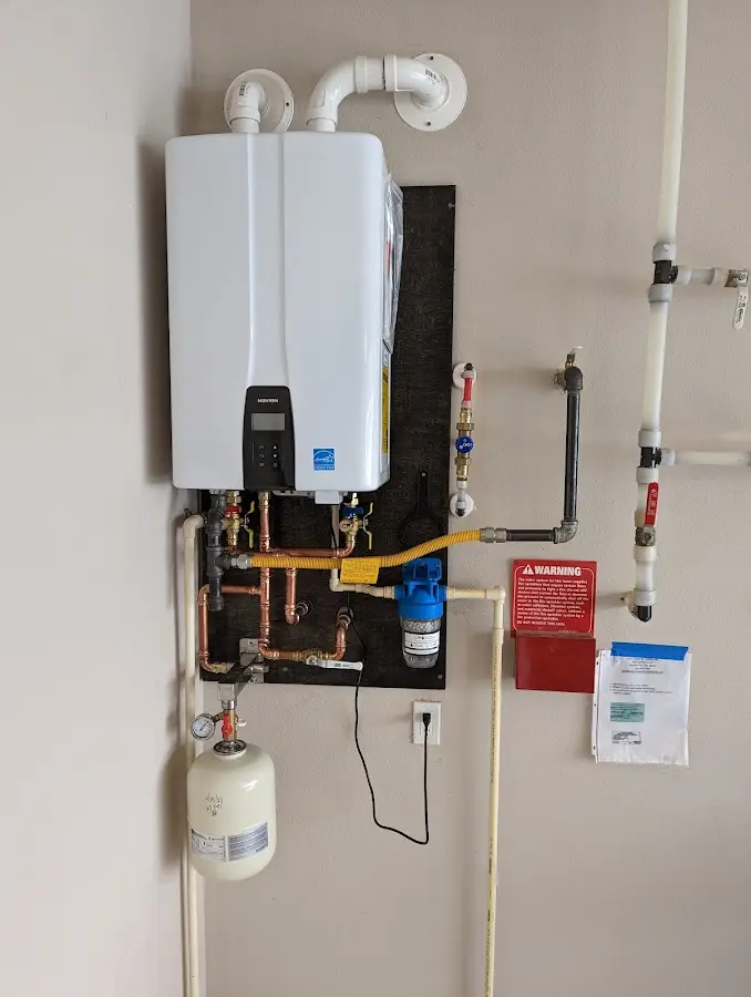 Professional plumber installing copper piping in a Baxter Village home